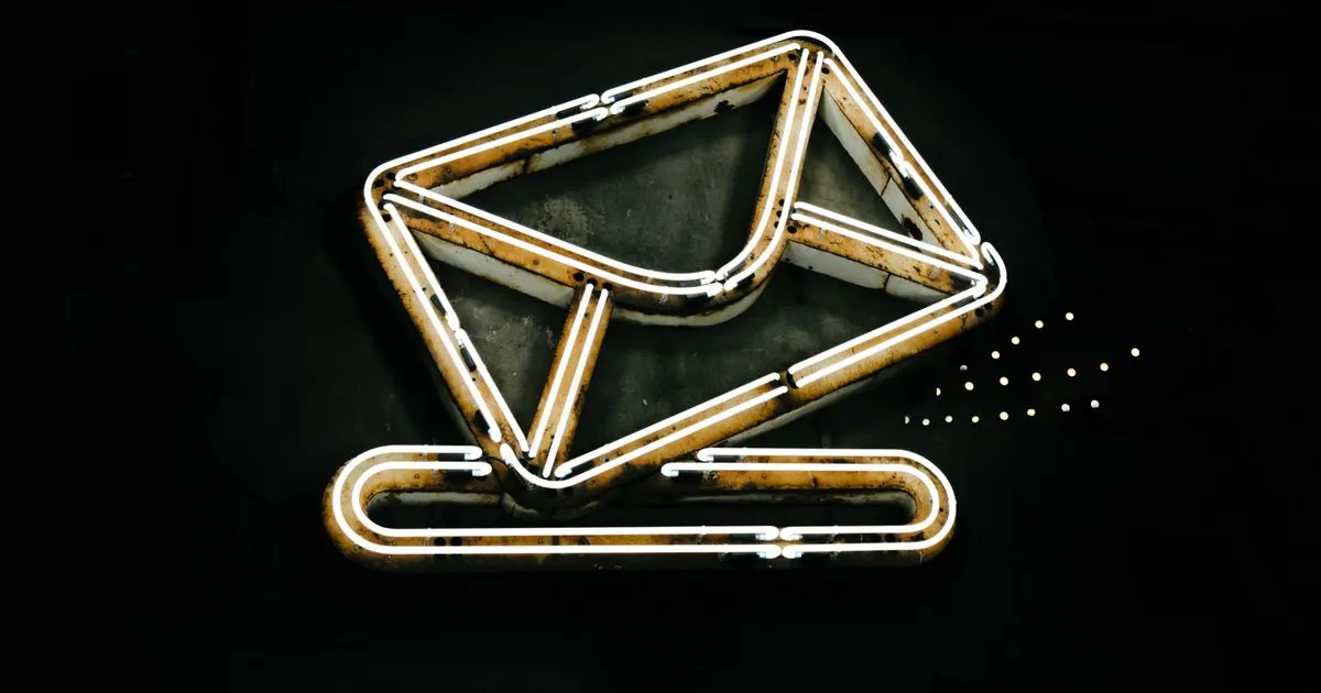 A glowing neon envelope sign