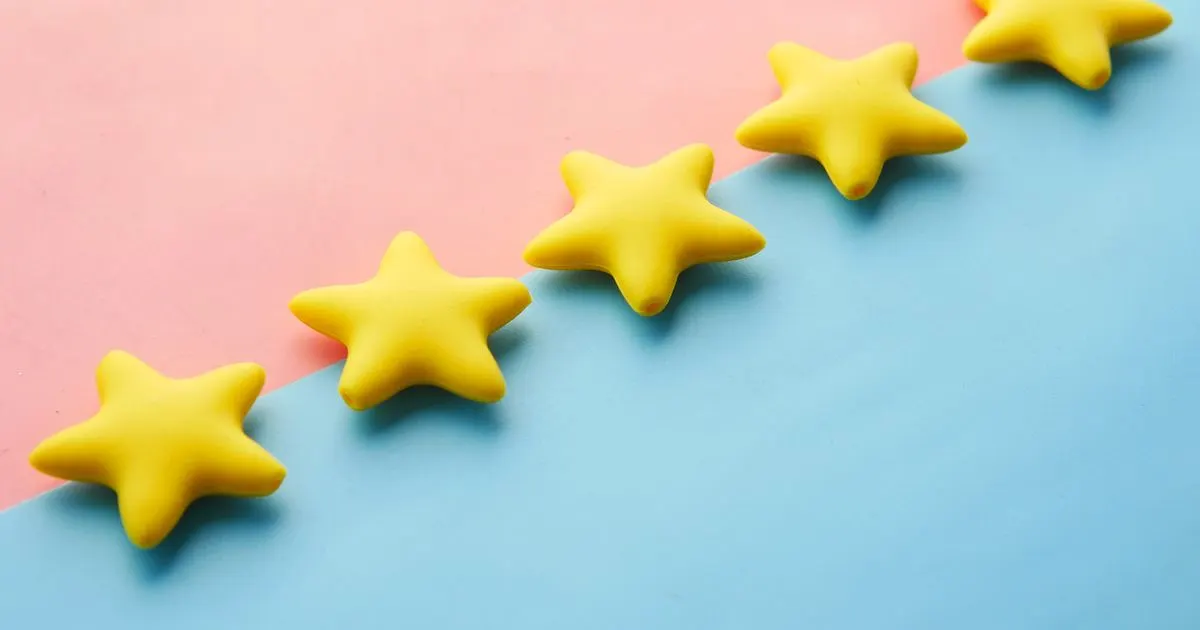 Five yellow stars on a pastel background