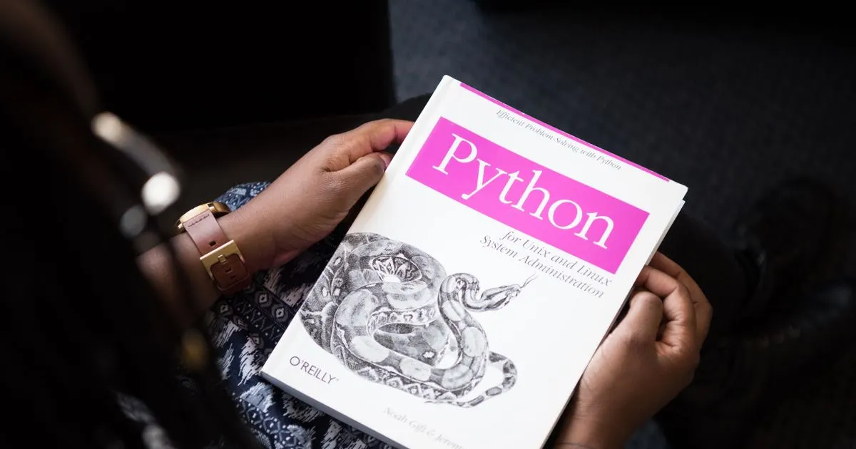 A learner holding a programming book